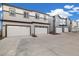 Row of modern townhomes showcasing attached garages, neutral siding, and well-maintained concrete driveway at 12570 Boggs St, Parker, CO 80134
