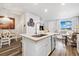 Open concept kitchen with stainless steel appliances, large island and view to dining and living spaces at 12570 Boggs St, Parker, CO 80134