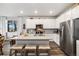 Modern kitchen with a large island, stainless steel appliances, and an open layout to the living area at 12570 Boggs St, Parker, CO 80134
