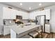 Charming kitchen featuring a large island with bar seating, stainless steel appliances, and ample cabinet space at 12570 Boggs St, Parker, CO 80134