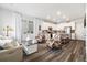 Bright living room flowing into an open kitchen, featuring modern finishes and plenty of natural light at 12570 Boggs St, Parker, CO 80134