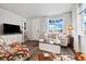 Cozy living room with neutral tones, modern furniture, and large windows allowing natural light at 12570 Boggs St, Parker, CO 80134