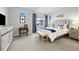 Luxurious main bedroom with large windows, elegant furnishings, and plush carpeting at 12570 Boggs St, Parker, CO 80134