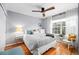 This bedroom features a ceiling fan, wood floors, neutral paint, and lots of natural light at 230 W Jamison Cir # 31, Littleton, CO 80120