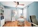 Bright bedroom featuring wood floors, a ceiling fan, a large closet, and comfortable seating at 230 W Jamison Cir # 31, Littleton, CO 80120