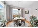 Charming dining room with a modern round table, stylish chairs, and a picturesque view from the large window at 230 W Jamison Cir # 31, Littleton, CO 80120