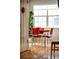 Bright dining area featuring a retro red table set, hardwood floors, and natural light from a large window at 230 W Jamison Cir # 31, Littleton, CO 80120