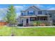 Charming two-story townhome with a well-manicured lawn and inviting front porch, creating a warm curb appeal at 230 W Jamison Cir # 31, Littleton, CO 80120