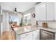 Open-concept kitchen with an island and seating, adjacent to the dining area and filled with natural light at 230 W Jamison Cir # 31, Littleton, CO 80120