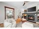 Warm and inviting living room with a cozy fireplace, comfortable seating, and open access to the dining area at 230 W Jamison Cir # 31, Littleton, CO 80120