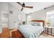 Bright main bedroom features a ceiling fan, wood floors, ensuite bathroom and lots of natural light at 230 W Jamison Cir # 31, Littleton, CO 80120