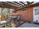 Outdoor patio with pergola, dining furniture, and view of a brick building at 6361 S Spotswood Cir, Littleton, CO 80120