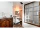 Stylish bathroom with modern vanity and unique glass block window at 6361 S Spotswood Cir, Littleton, CO 80120