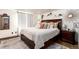 Comfortable bedroom with a large bed, a full mirror, and natural lighting at 6361 S Spotswood Cir, Littleton, CO 80120