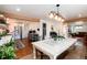 Bright dining room featuring a large table and access to the open-concept kitchen at 6361 S Spotswood Cir, Littleton, CO 80120