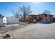 Exterior view showing detached garage, the deck with stairs and the home at 6361 S Spotswood Cir, Littleton, CO 80120