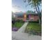 Inviting front exterior featuring a brick home, manicured lawn, and a charming front porch at 6361 S Spotswood Cir, Littleton, CO 80120