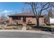 Charming brick home featuring a cozy front porch and a well-manicured front yard at 6361 S Spotswood Cir, Littleton, CO 80120