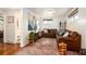 Cozy living room featuring a comfortable brown leather sofa and accent rug at 6361 S Spotswood Cir, Littleton, CO 80120