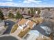 An aerial of a neighborhood featuring well-maintained homes, mature trees, and tennis courts at 12592 E Bates Cir, Aurora, CO 80014