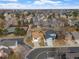 An aerial view of a neighborhood featuring well-maintained homes, mature trees, and tennis courts at 12592 E Bates Cir, Aurora, CO 80014