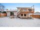 Backyard with second story deck, stairs to the yard, and mature trees at 12592 E Bates Cir, Aurora, CO 80014