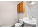 Well-lit bathroom featuring a modern toilet, vanity, and built-in cabinet with ample storage space at 12592 E Bates Cir, Aurora, CO 80014