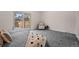 Bedroom with large sliding glass door, patterned chair, and carpet at 12592 E Bates Cir, Aurora, CO 80014