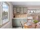 Dining area featuring built-in cabinetry, a round wood table, and a view to the outside at 12592 E Bates Cir, Aurora, CO 80014