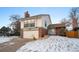 Two story home featuring brick accents, an attached garage, and a well-manicured lawn with mature trees at 12592 E Bates Cir, Aurora, CO 80014