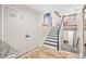 Entryway featuring a staircase, tiled floor, and closet for convenient storage at 12592 E Bates Cir, Aurora, CO 80014