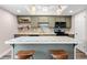 Well-equipped kitchen featuring custom cabinetry, modern appliances and a center island with stool seating at 12592 E Bates Cir, Aurora, CO 80014