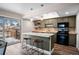 Functional eat-in kitchen offering bar stool seating, lots of counterspace and sliding doors to an outdoor deck at 12592 E Bates Cir, Aurora, CO 80014