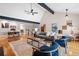 Comfortable living room with vaulted ceilings, wood floors, beams and view to the stairway and dining room at 12592 E Bates Cir, Aurora, CO 80014