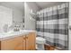 Bathroom featuring a vanity, toilet, mirror and a shower curtain at 5562 Gibraltar St, Denver, CO 80249