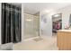 Modern bathroom showcasing tiled shower with glass door and vanity with sink at 5562 Gibraltar St, Denver, CO 80249