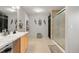 Modern bathroom featuring marble countertop vanity, tiled shower and decorative accents at 5562 Gibraltar St, Denver, CO 80249