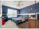 Comfortable bedroom with bright blue walls, a window and a ceiling fan at 5562 Gibraltar St, Denver, CO 80249