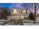 Charming two-story home featuring stone accents, red shutters, well-kept lawn and two-car garage at 5562 Gibraltar St, Denver, CO 80249