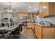 Well-equipped kitchen with wooden cabinets and stainless steel appliances adjacent to the dining area at 5562 Gibraltar St, Denver, CO 80249