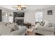 Living room with hardwood floors, a fireplace, and comfortable seating at 5562 Gibraltar St, Denver, CO 80249