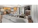 Open-concept living room with hardwood floors and adjacent kitchen and dining area at 5562 Gibraltar St, Denver, CO 80249