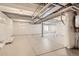 Spacious unfinished basement with white walls, concrete floor, and exposed pipes, ready for customization at 305 Welded Tuff Trl, Castle Rock, CO 80104