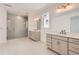 Primary bathroom featuring dual sinks, modern fixtures, glass enclosed shower, and neutral finishes at 305 Welded Tuff Trl, Castle Rock, CO 80104