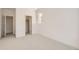 Bright bedroom with neutral carpet, white walls, window, closet and passageway to additional room at 305 Welded Tuff Trl, Castle Rock, CO 80104