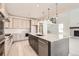 Modern kitchen with a large island, stainless steel appliances, and a view to the adjacent living area at 305 Welded Tuff Trl, Castle Rock, CO 80104