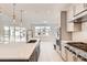 Modern kitchen boasts stainless steel appliances, stylish fixtures, and a large island with quartz countertops at 305 Welded Tuff Trl, Castle Rock, CO 80104