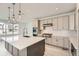 Elegant kitchen featuring stainless steel appliances, light gray cabinetry, and a spacious island with pendant lighting at 305 Welded Tuff Trl, Castle Rock, CO 80104