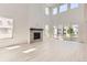 Spacious living room featuring a modern fireplace, tall windows, and sliding glass doors to the exterior at 305 Welded Tuff Trl, Castle Rock, CO 80104