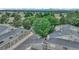 Overhead view of a residential community with garages, lush trees, and a street at 8055 E Colorado Ave # 8, Denver, CO 80231